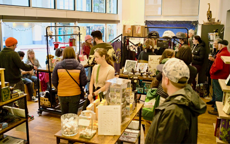 Photo features people shopping in a busy store.